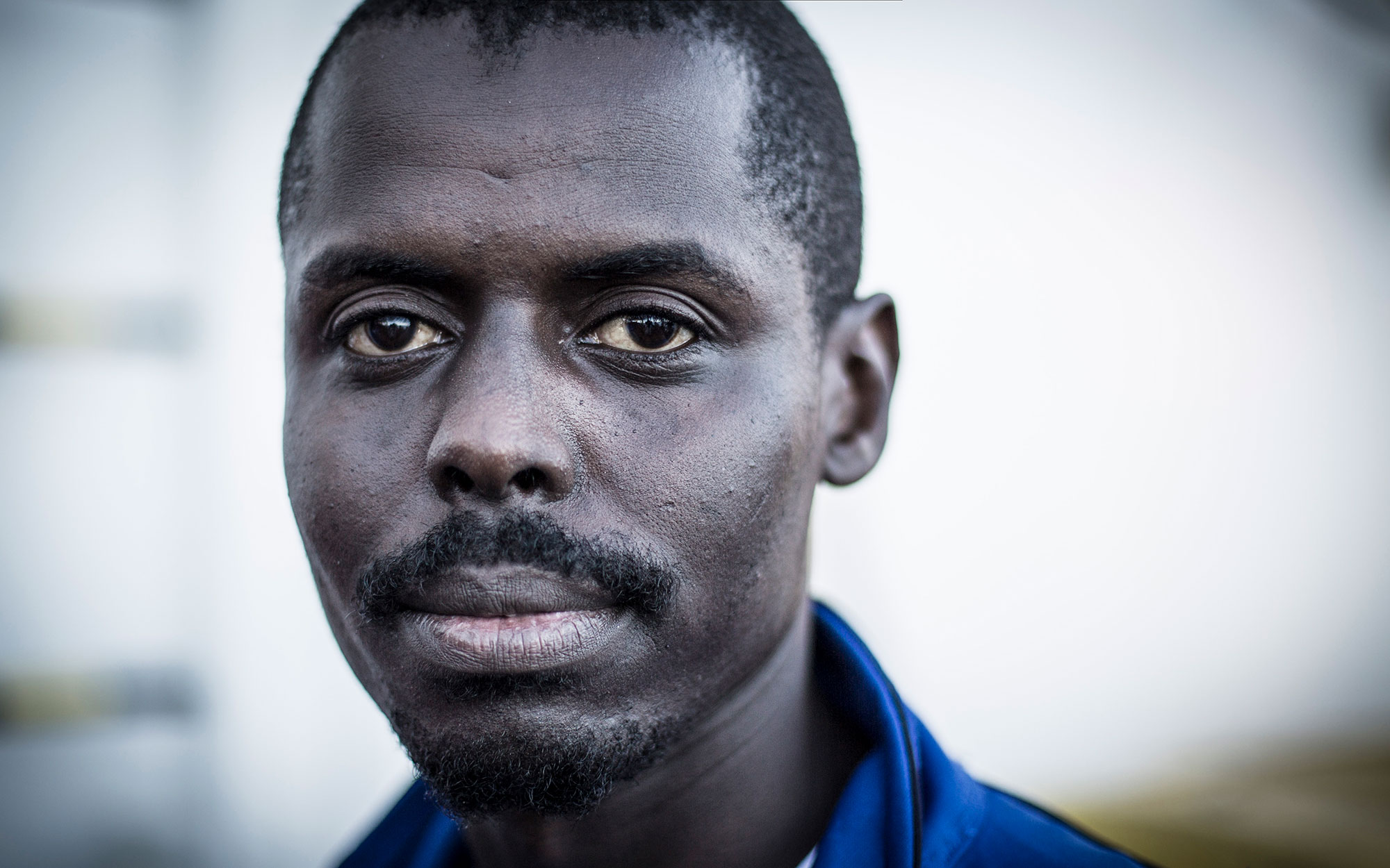 Photograph of Adam, a 24-year-old from Darfur.