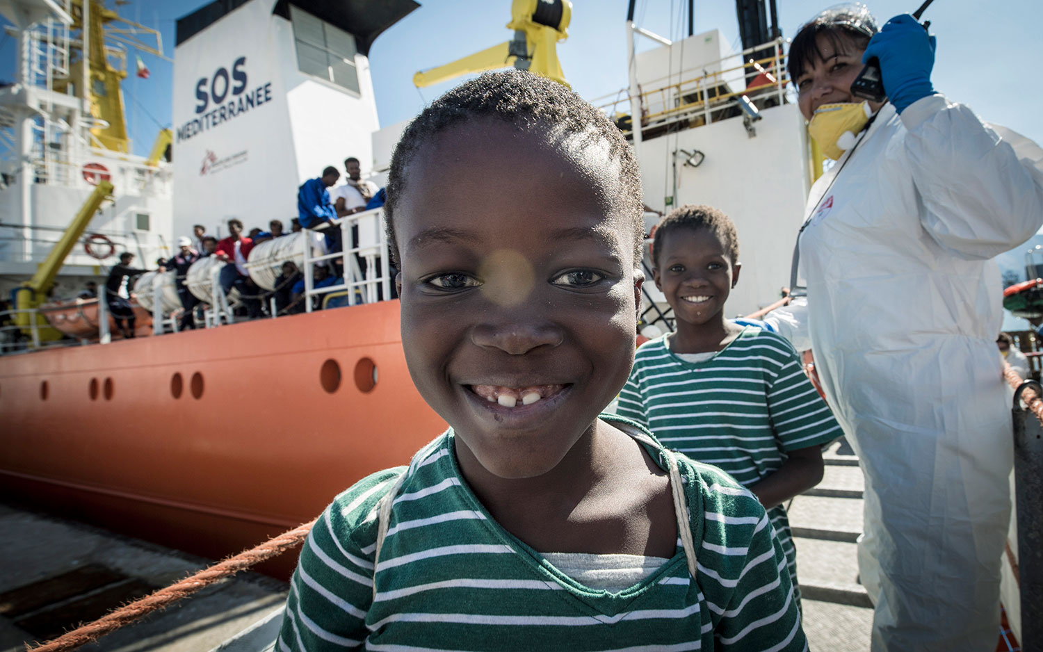 Lorum ipsum dolor; Children smile as they disembark the Aquarius in Palermo. October 13, 2017.